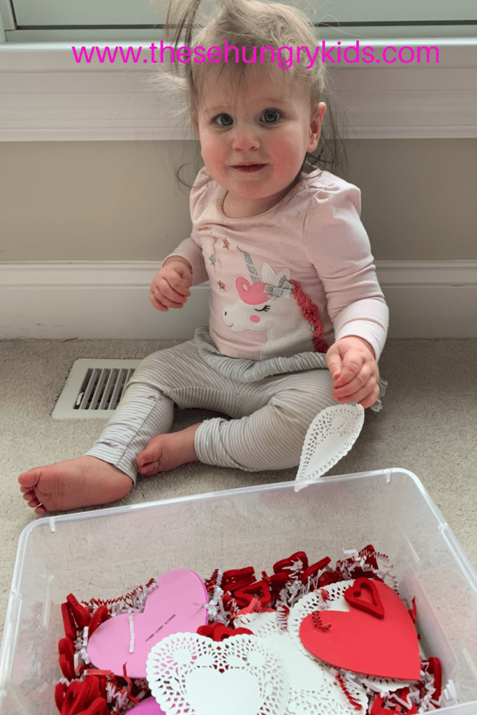 Toddler playing in sensory bin valentine