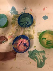 Toddler painted with edible bathtub paint